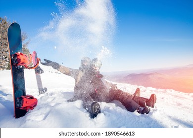Loving couple of snowboarders woman and man hugging on top of mountain, concept of active winter sport weekend. - Powered by Shutterstock