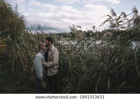 Similar – Image, Stock Photo Couple kissing on the field