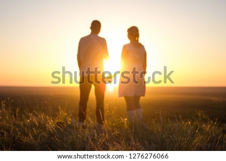 loving couple at sunset holding hands, the concept of eternal love