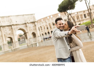Loving Couple Taking Selfie In Front Of The Colosseum