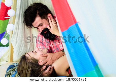 Loving couple in tent. Couple in love hugging kissing near tent in camping. Portrait of a happy couple in love hug outdoors. Passionate horny woman with lover feeling pleasure