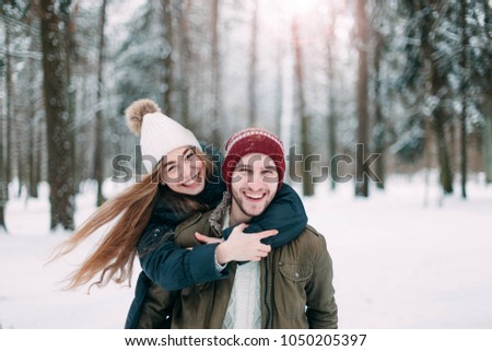 
loving couple in the woods in winter. Positive romance.
