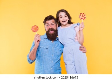 Loving Daddy And Small Girl Eating Lollipop. Summer Vacation. Happy Holidays. Sweet Childhood. When Children Seem Hard To Please. Daughter And Father Eat Sweet Candy. Bearded Man And Cute Sweet Baby