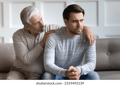 Loving elderly 70s Caucasian father hug comfort upset distressed grownup son feeling depressed or broken. Caring mature dad caress embrace show support and empathy to unhappy adult man kid. - Powered by Shutterstock