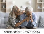 Loving empathetic mature wife consoling depressed elder husband, giving comfort, support, empathy, sharing sorrow, despair. Senior couple facing problems, crisis