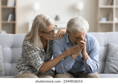 Loving empathetic mature wife consoling depressed elder husband, giving comfort, support, empathy, sharing sorrow, despair. Senior couple facing problems, crisis - Powered by Shutterstock