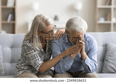 Loving empathetic mature wife consoling depressed elder husband, giving comfort, support, empathy, sharing sorrow, despair. Senior couple facing problems, crisis