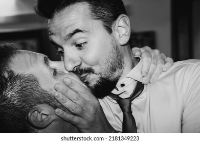 Loving Gay Couple Kissing Passionately At The Wedding Party - Two Handsome Men Having Romantic Kiss Indoors - LGBT Wedding And Rights Concept - Black And White