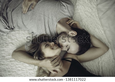 Similar – Happy young couple in love kissing under duvet cover