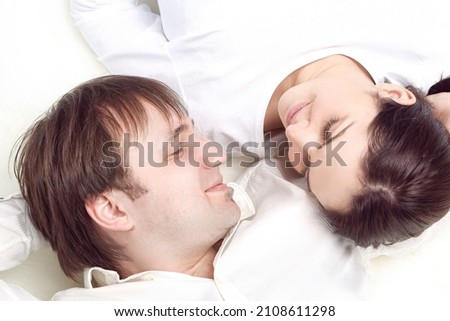 Similar – Image, Stock Photo Young couple in love embracing lying over a bed