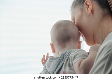 Loving Happy Mum Carrying Of Newborn Baby At Home. Portrait Parent Of Holding Infant Child On Hands. Mother Care Little 6 Months Old Child. Concept Of Motherhood And Parental Care. Copy Space