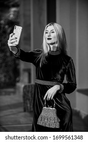 Loving Her New Style. Fashion Blog. Elegant Woman Green Velour Dress. Glamour Velvet Textile. Sexy Businesswoman Make Selfie On Phone. Modern Life. Girl Care Gem Stone Handbag. Glam Clutch Accessory.