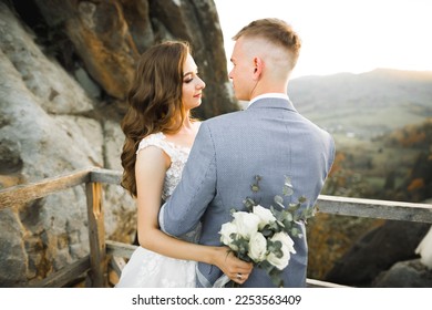 Loving husband and woman on the background of the mountains. Loving couple emotionally spends time - Shutterstock ID 2253563409