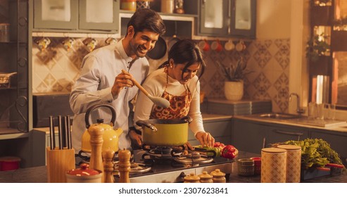 Loving Indian Couple Preparing Food Together in the Kitchen: Young Lovely Couple Enjoy Spending Time together, Learning New things, Creating Delicious Experiences. Preparing Dinner For Family, Friends - Shutterstock ID 2307623841