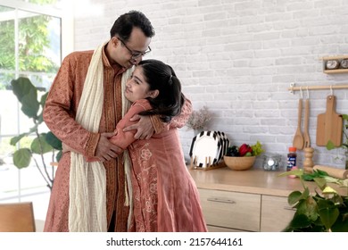 Loving Indian daddy and adorable daughter feeling love are hugging, looking at camera and in kitchen at home, fathers day concept - Shutterstock ID 2157644161