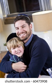 Loving Jewish father and young 4 year old son wearing yarmulkes