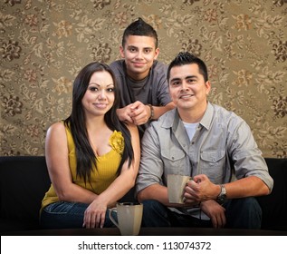 Loving Latino Family Of Three Sitting Together