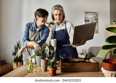 Loving lesbian couple captivated by laptop screen in cozy kitchen. - Powered by Shutterstock