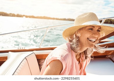 Loving life out here. a mature woman enjoying a relaxing boat ride. - Powered by Shutterstock