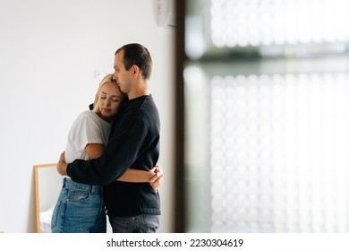 Loving man comforting supporting hugging partner wife feeling emotional sad depressed. Unhappy young couple having relationship trouble, embracing emotional issues, sharing bad news at home. - Powered by Shutterstock