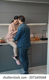 Loving Mature Couple Cuddling During Morning In Kitchen