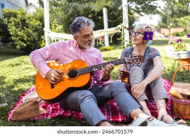 Loving mature couple with guitar in park - Powered by Shutterstock