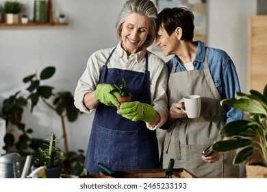 A loving mature lesbian couple wearing aprons, taking care of plants. - Powered by Shutterstock