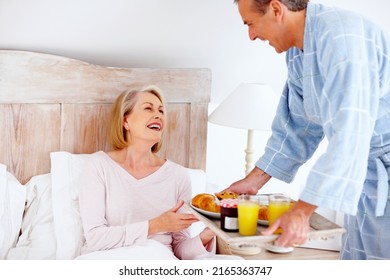 Loving Mature Man Serving Breakfast To His Wife In Bed. Portrait Of Loving Mature Man Serving Breakfast To His Wife In Bed.