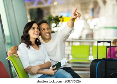 Loving Mid Age Couple At Airport Waiting For Their Flight 