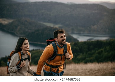 Loving mid aged couple with a backapacks hiking on the hills together - Powered by Shutterstock