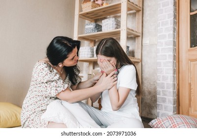 A Loving Middle-aged Mother And Daughter Sit On The Floor, A Worried Parent Calms A Child With A Broken Heart, First Love,