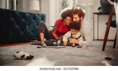 Loving Mixed Race Family Playing With Toys With Adorable Baby Boy At Home On Living Room Floor. Cheerful Mother And Father Nurturing A Child. Concept Of Childhood, New Life, Parenthood.