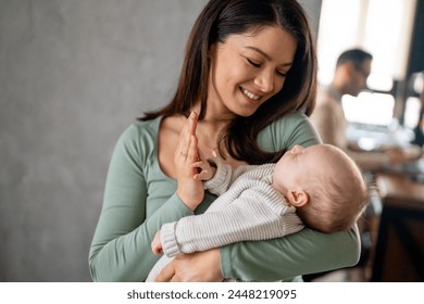 Loving mother carying of her newborn baby at home. Family parenting baby love concept. - Powered by Shutterstock