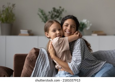 Loving mother cuddling her little cute daughter, family sit on cozy sofa at home smile look at camera enjoy tender moment full of love. Happy motherhood, portrait of caring mom and 5s child concept - Shutterstock ID 2181037913