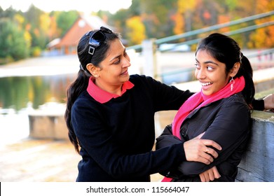 Loving Mother And Daughter Talking To Each Other In Outdoors