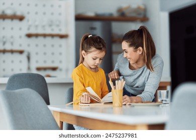 A loving mother encouraging her young daughter and praising her drawing skills as they go through her sketchbook together. - Powered by Shutterstock