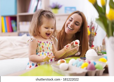 Loving Mother And Her Baby Painting Easter Eggs 