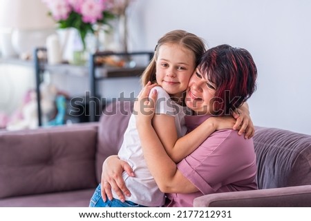 loving mother hugs a sweet daughter, feeling a tender connection, a happy woman caresses a little girl, a mother hugs a child, warm relations, custody of children, the concept of a foster family