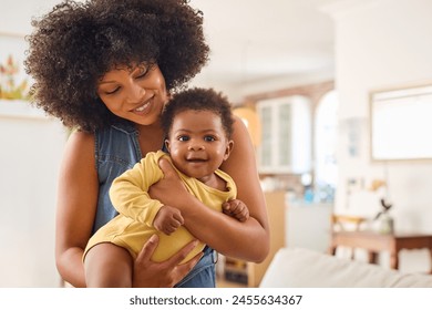 Loving Mother Indoors At Home Standing Cuddling Baby Daughter - Powered by Shutterstock