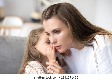 Loving Mother Listens To Child Girl Whispering In Ear Telling Psychological Problem, Serious Caring Mom Supporting Little Daughter Share Secret, Honesty Trust Understanding In Parent And Kid Relation