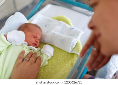 Loving Mother And Newborn Baby Boy Sad Crying
In Hospital
