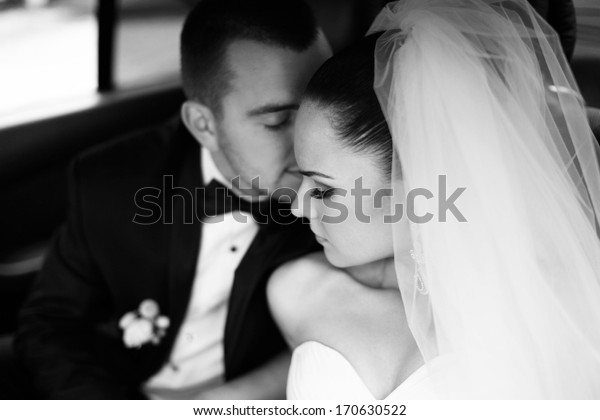 Loving newlywed
bride and bridegroom in
car