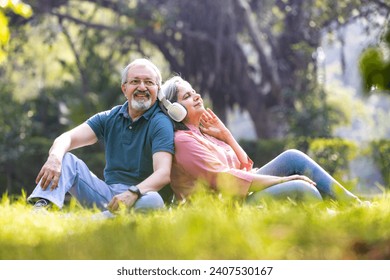 Loving old couple spending leisure time listening music during sunny day - Powered by Shutterstock