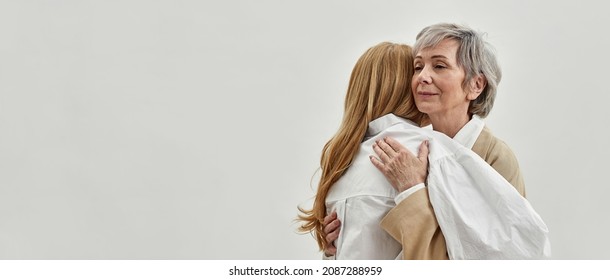 Loving Old Grey-haired Mother Hug Support Adult Daughter, Isolated On Whites Studio Background. Caring Supportive Mature Mom Embrace Comfort Caress Grownup Child. Copy Space, Banner.