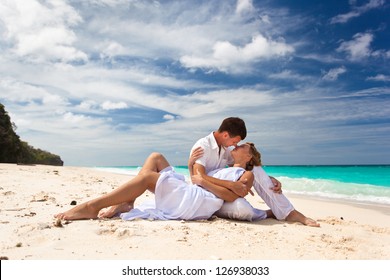 Loving pair sitting on the beach