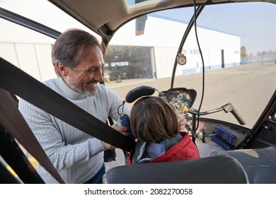 Loving Parent Gearing His Child Up For A Helicopter Ride