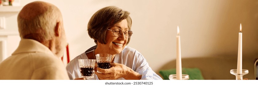 A loving senior couple toasting with glasses of red wine in a cozy Christmas setting. - Powered by Shutterstock