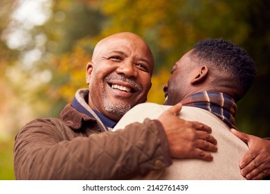 Loving Senior Father Hugging Adult Son On Walk Through Autumn Countryside - Powered by Shutterstock