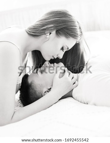 Similar – Man looking to beautiful woman lying on bed