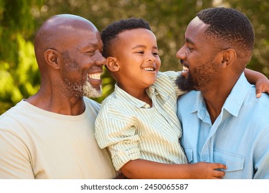 Loving Three Generation Male Family Laughing And Hugging Outdoors In Countryside - Powered by Shutterstock